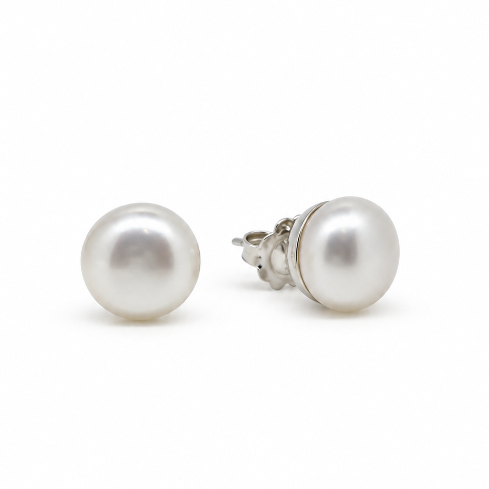 A pair of classic freshwater pearl stud earrings with silver posts, shown on a clean white background.
