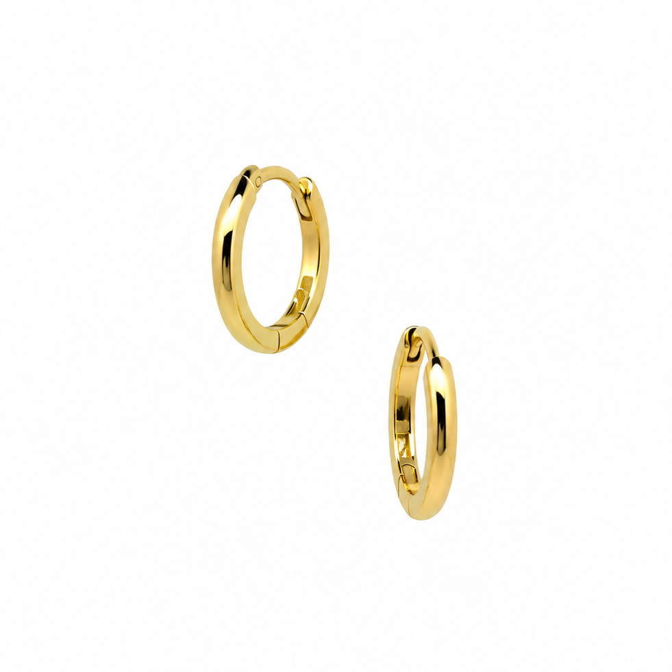 A pair of polished gold huggie hoop earrings on a solid white background.