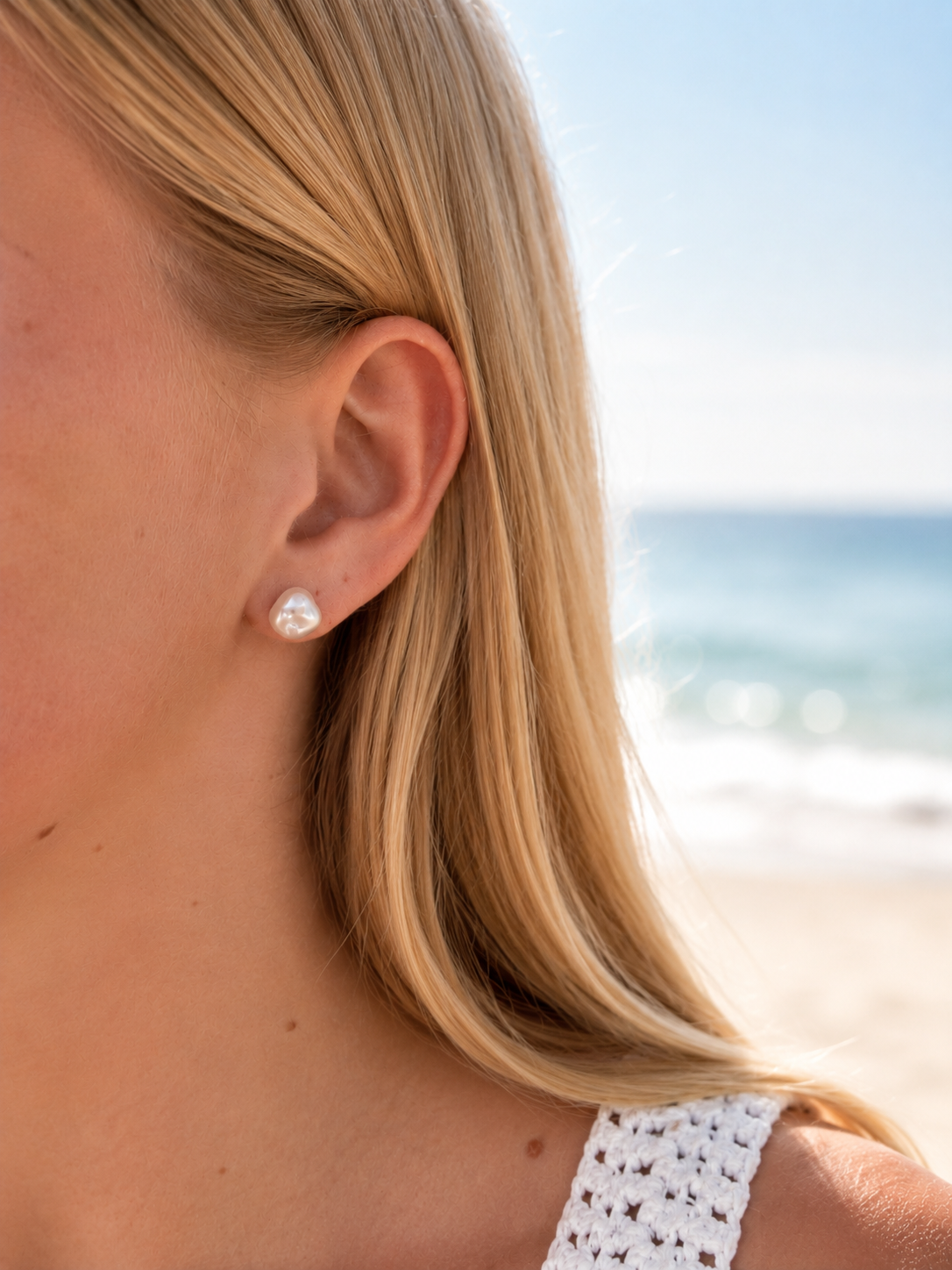 9mm keshi pearl stud earrings in gold vermeil, styled in a natural beach setting with a coastal Australian jewellery vibe