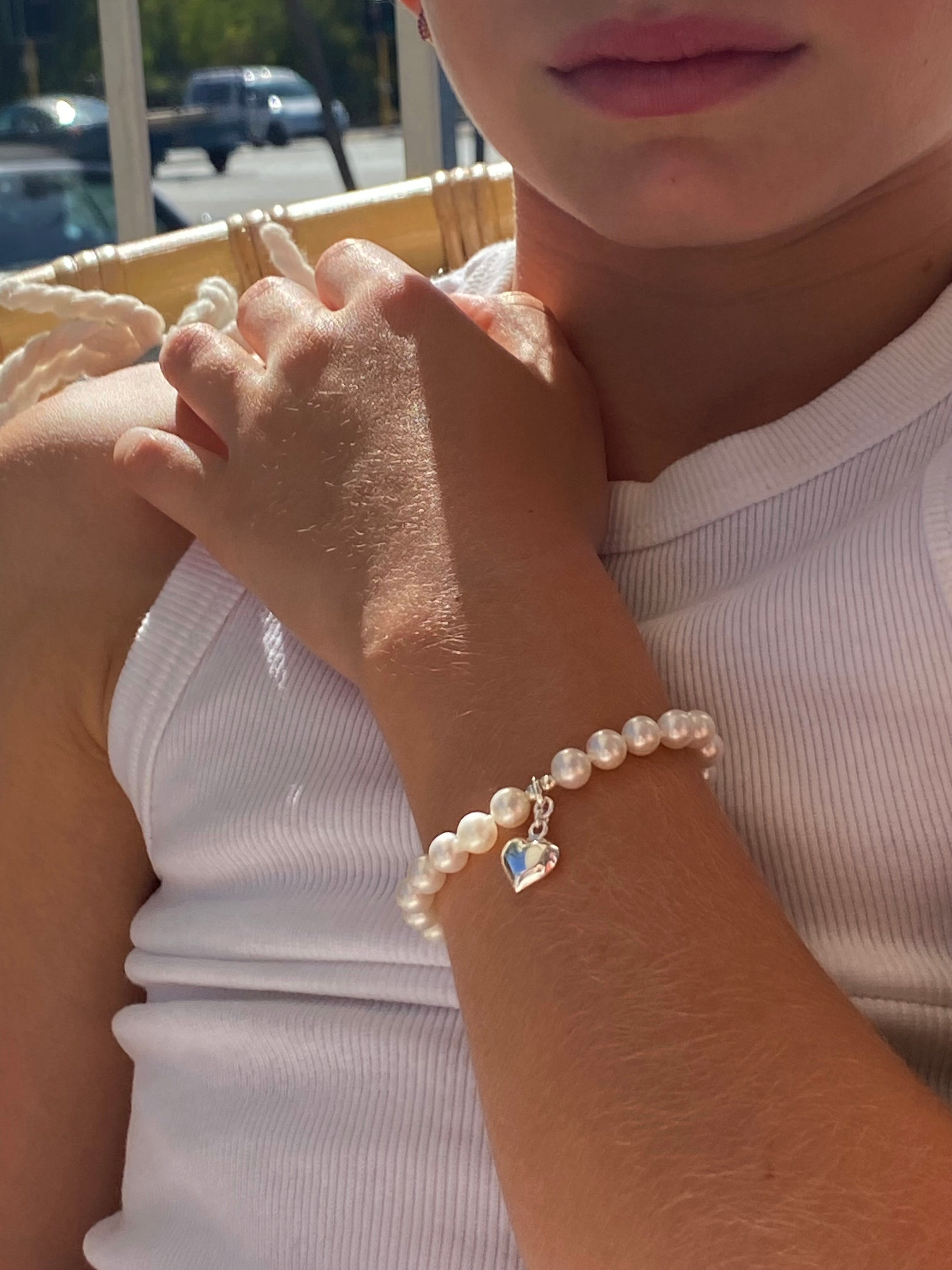 pearl children’s bracelet with silver heart charm  
