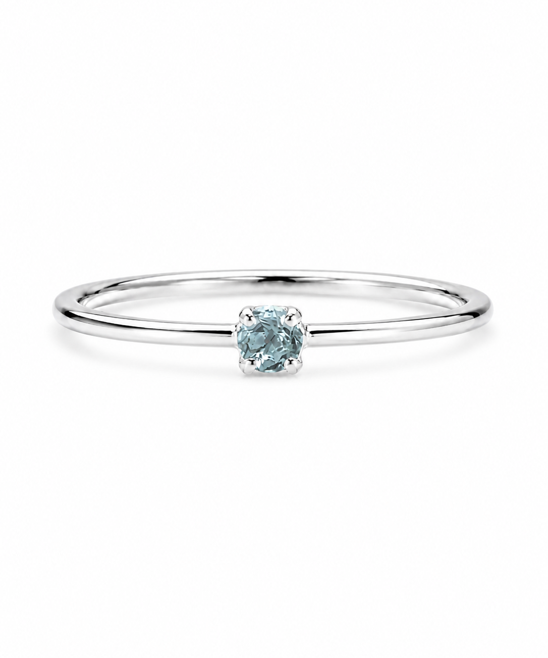 A delicate sterling silver ring featuring a single round-cut light blue gemstone in a prong setting