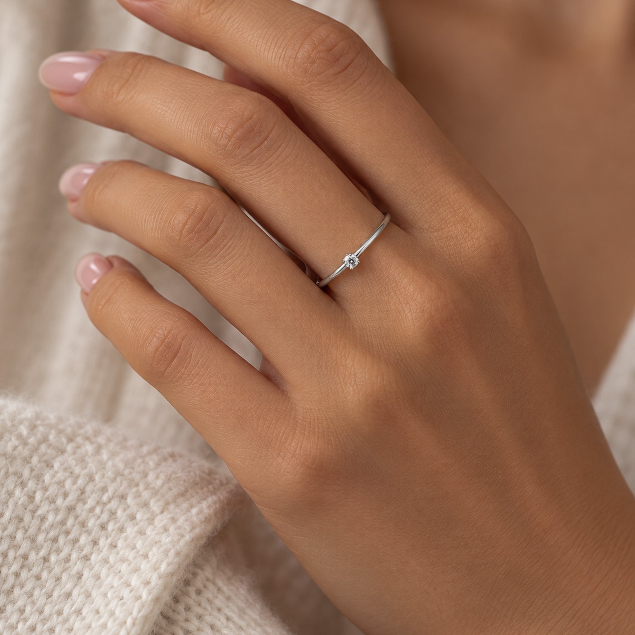 A silver dainty ring with a topaz light blue stone.