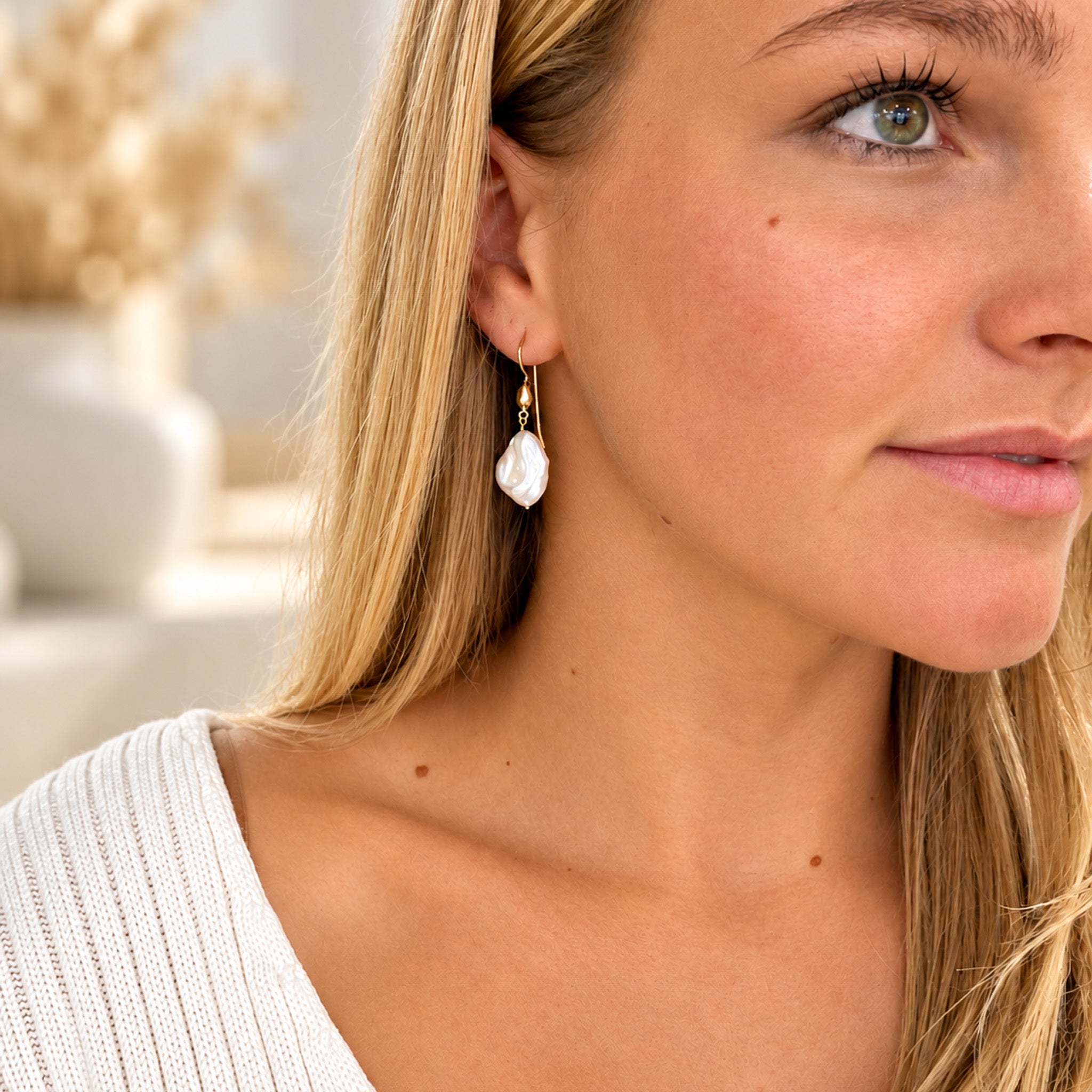 Gold vermeil hook earrings with natural 15mm white baroque freshwater pearls showing their unique organic shapes and lustrous finish.