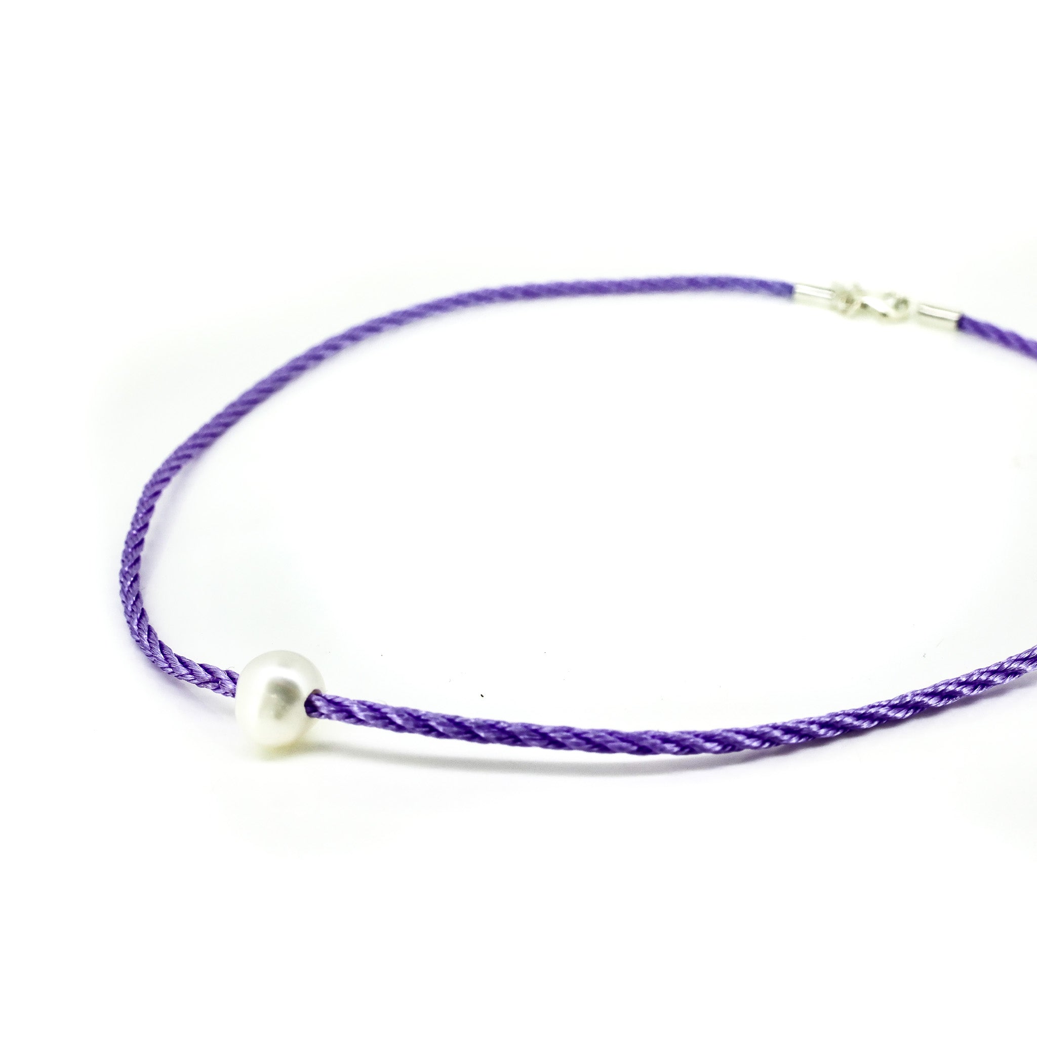 Childrens pearl necklace on purple braid cord