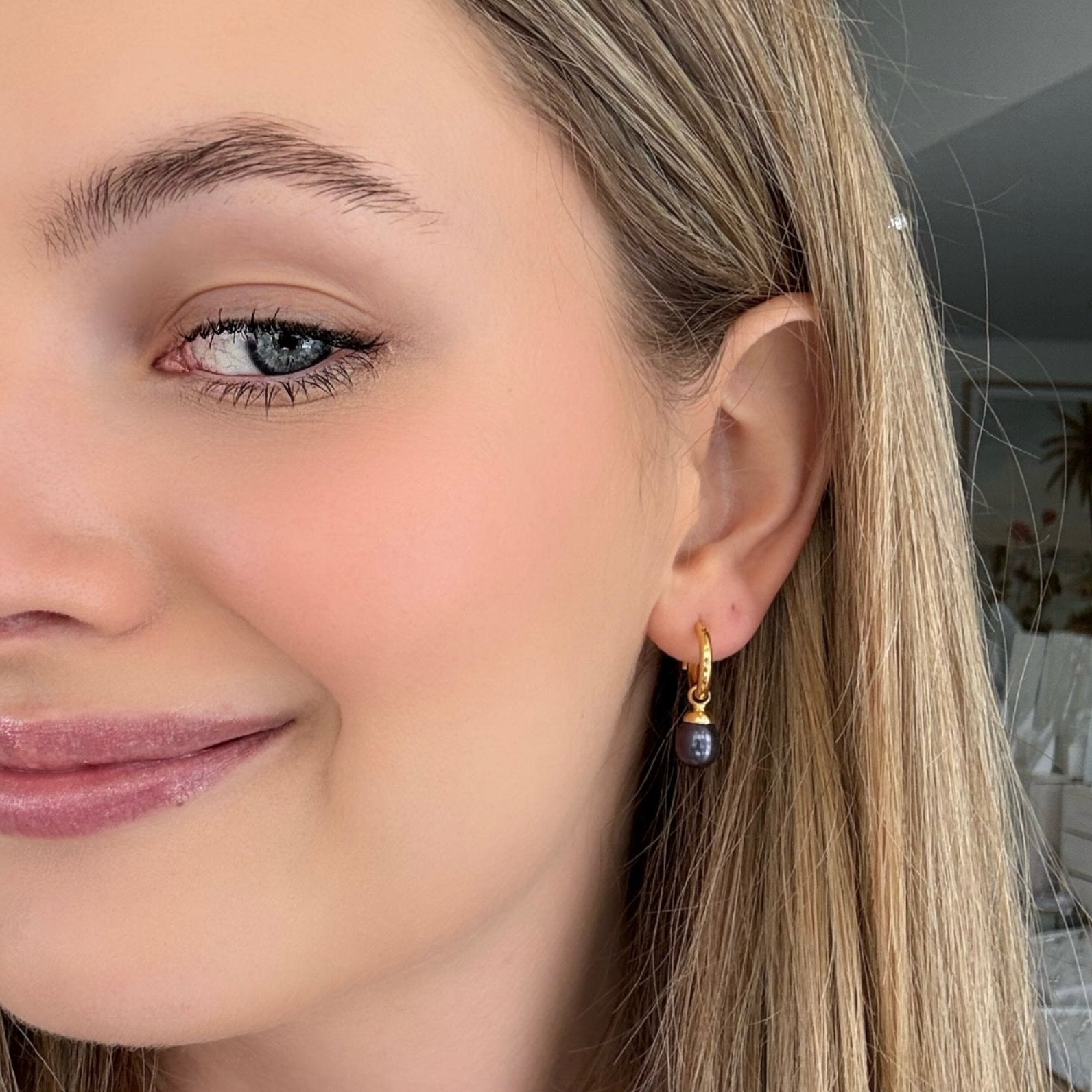 Gold sleeper earrings with black freshwater pearls designed in Broome Western Australia