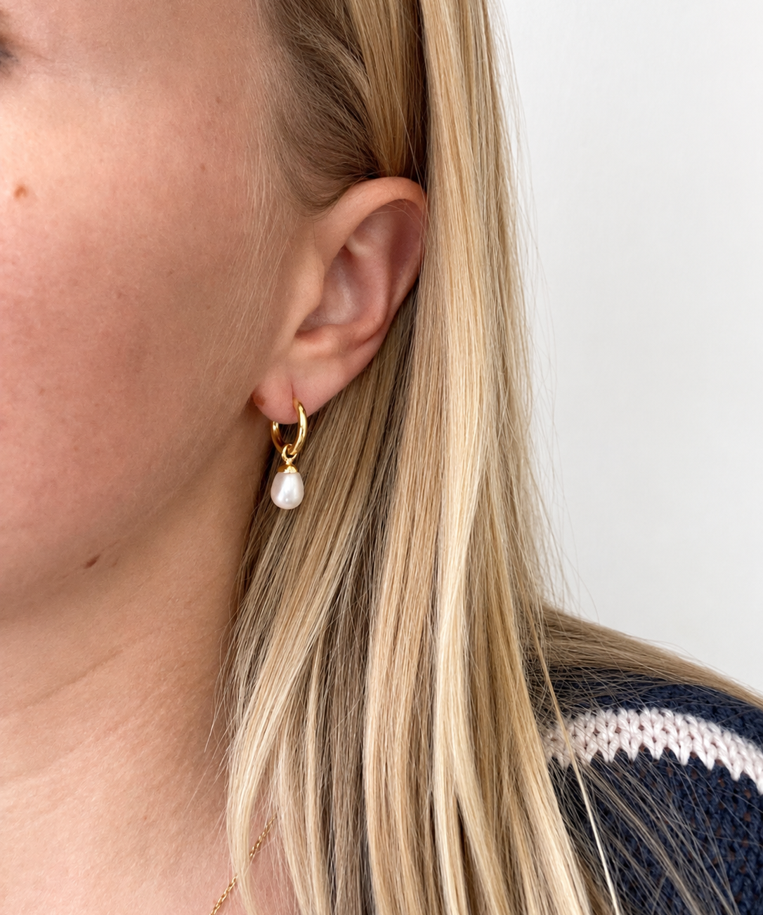 Eternal Summer Sleepers 9mm Gold featuring a delicate gold hoop with a 9mm freshwater pearl drop, worn on the ear.