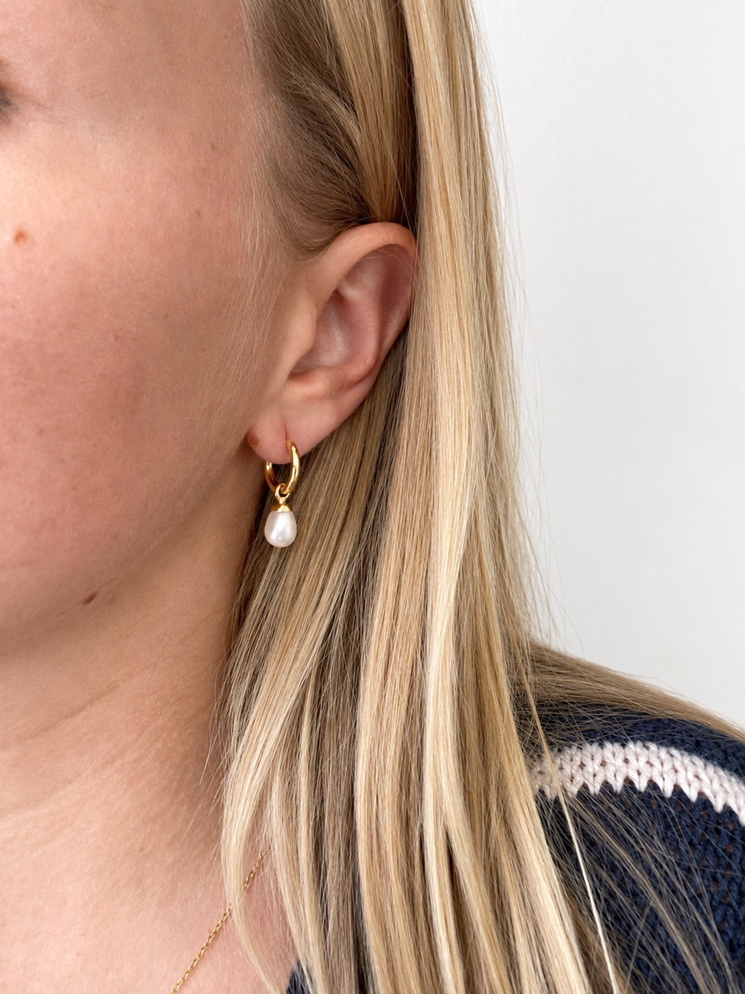 Eternal Summer Sleepers 9mm Gold featuring a delicate gold hoop with a 9mm freshwater pearl drop, worn on the ear.