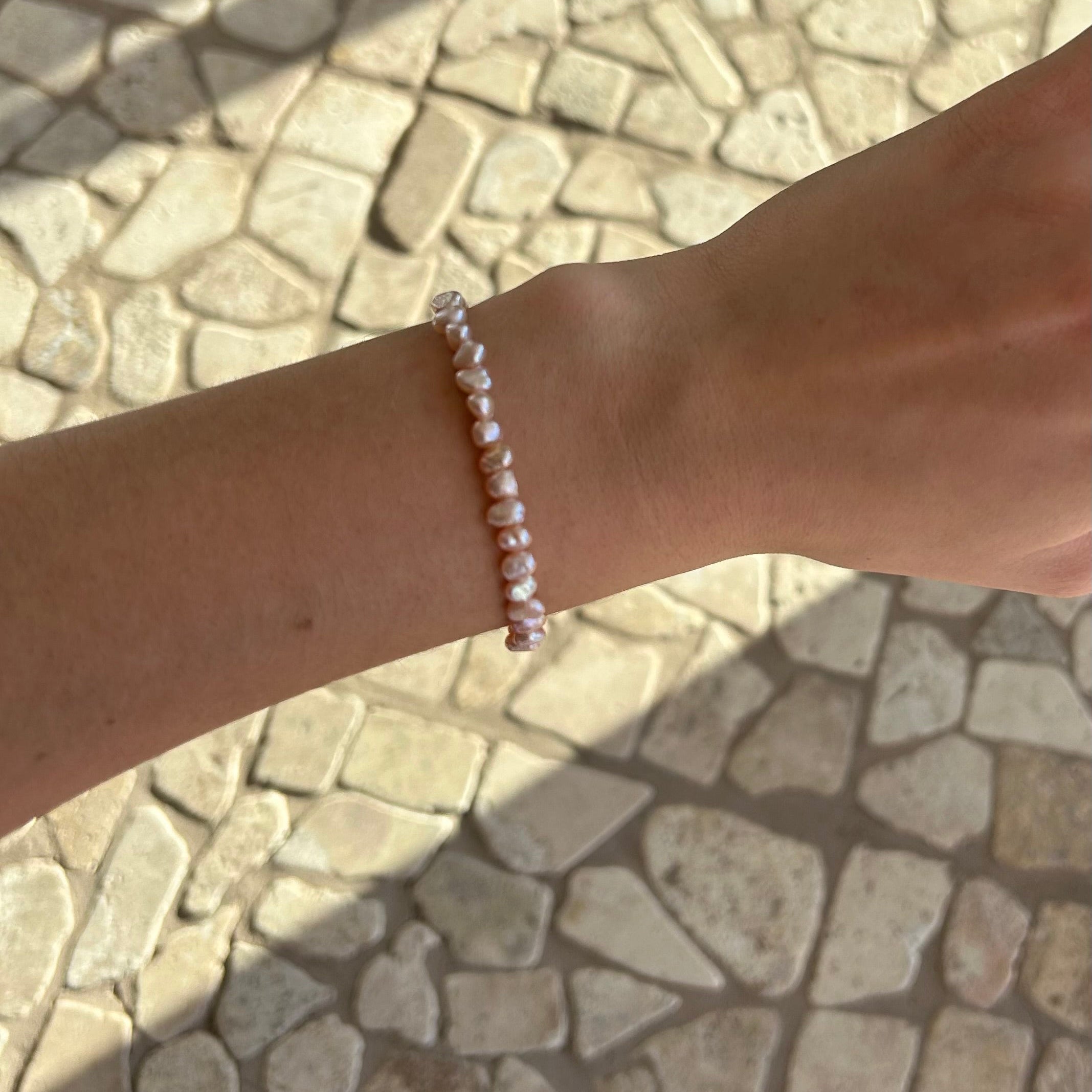 Delicate pink freshwater pearl stretch bracelet for girls, featuring natural blush-toned pearls and an easy elastic fit. Designed in Broome Western Australia.