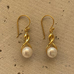 Infinity Pearl Hook Earrings Gold featuring lustrous white pearls and an elegant infinity design with delicate gold hooks.