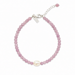 Pink pearl gemstone bracelet with faceted blush beads, genuine freshwater pearl, sterling silver adjustable chain, and LUSH tag worn on a sun-kissed wrist by the ocean.