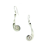 Silver earrings with pearl centers on a white background