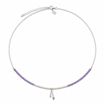A delicate silver chain necklace featuring a curved row of small purple beads on each side, with a central section of white pearls and a dangling charm, shown on a plain white background.