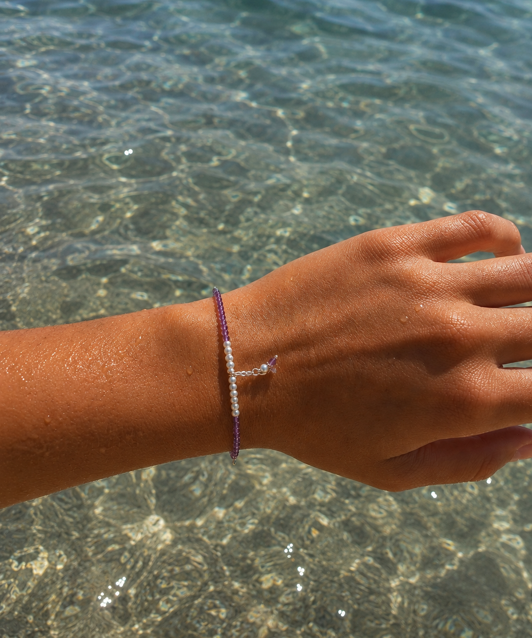 Ocean Spell Pearl Bracelet Amethyst featuring genuine amethyst gemstones, freshwater pearls and sterling silver accents on an adjustable bracelet.