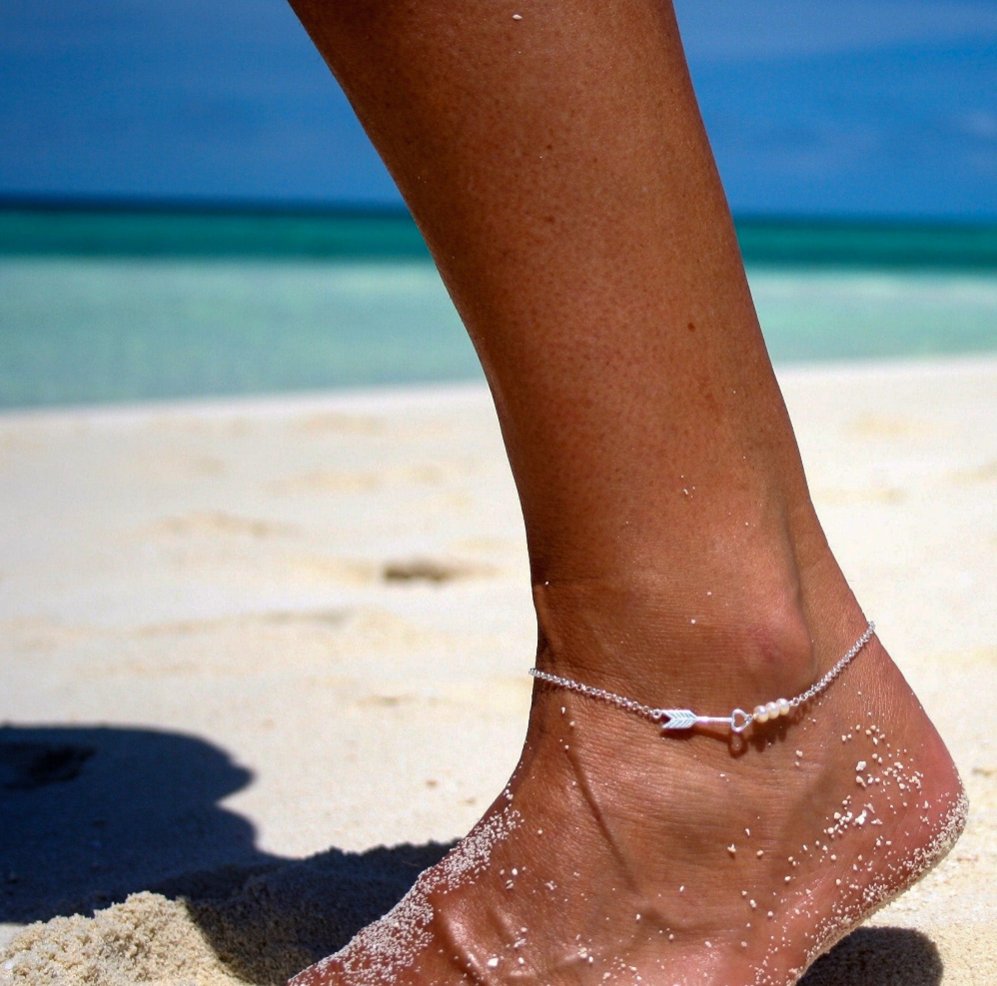 Pearl Tide Arrow Anklet Silver by Lush Designs Jewellery, featuring three white pearls, sterling silver heart-and-arrow charm, adjustable chain and LUSH tag.