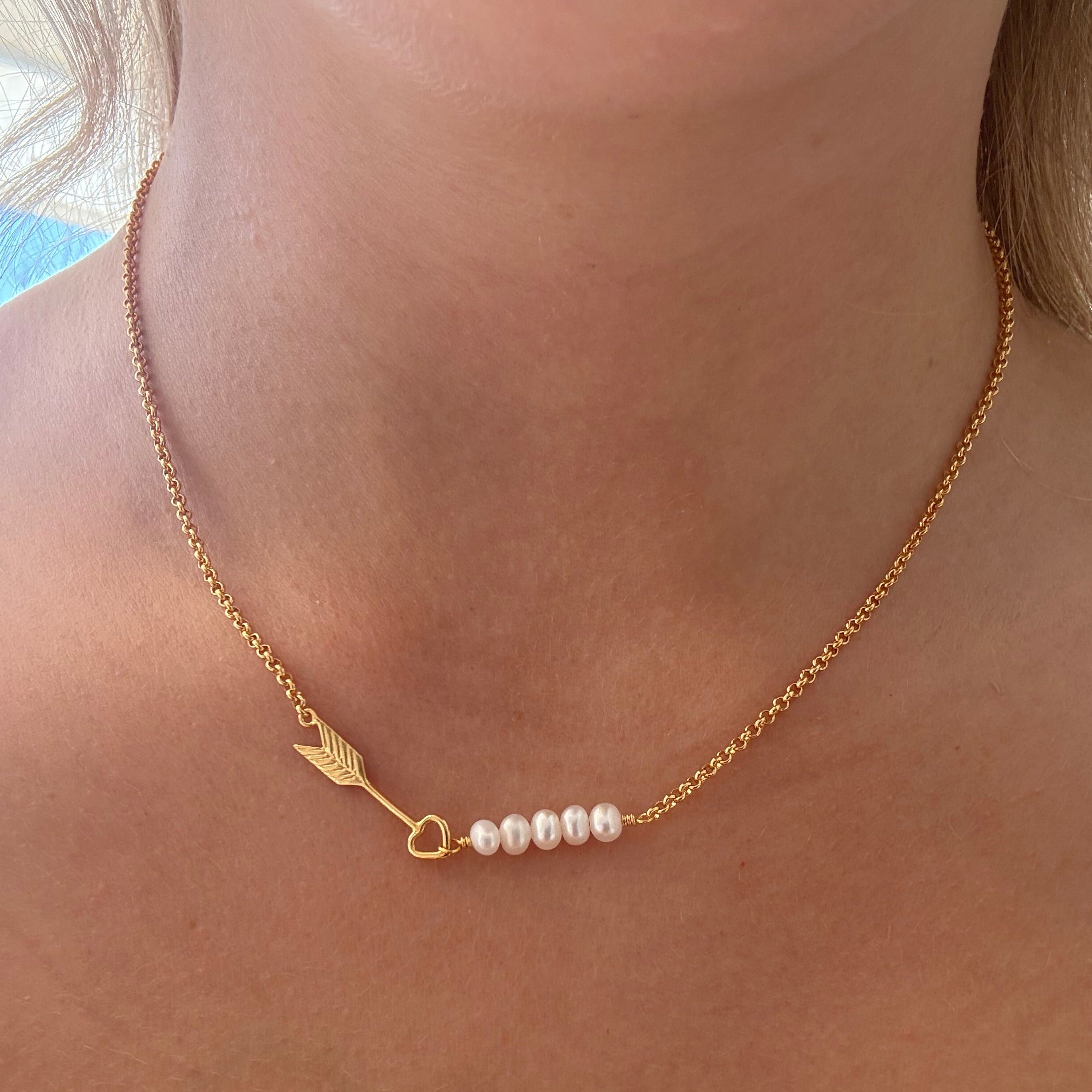 Dainty gold necklace with arrow detail and dainty freshwater pearls