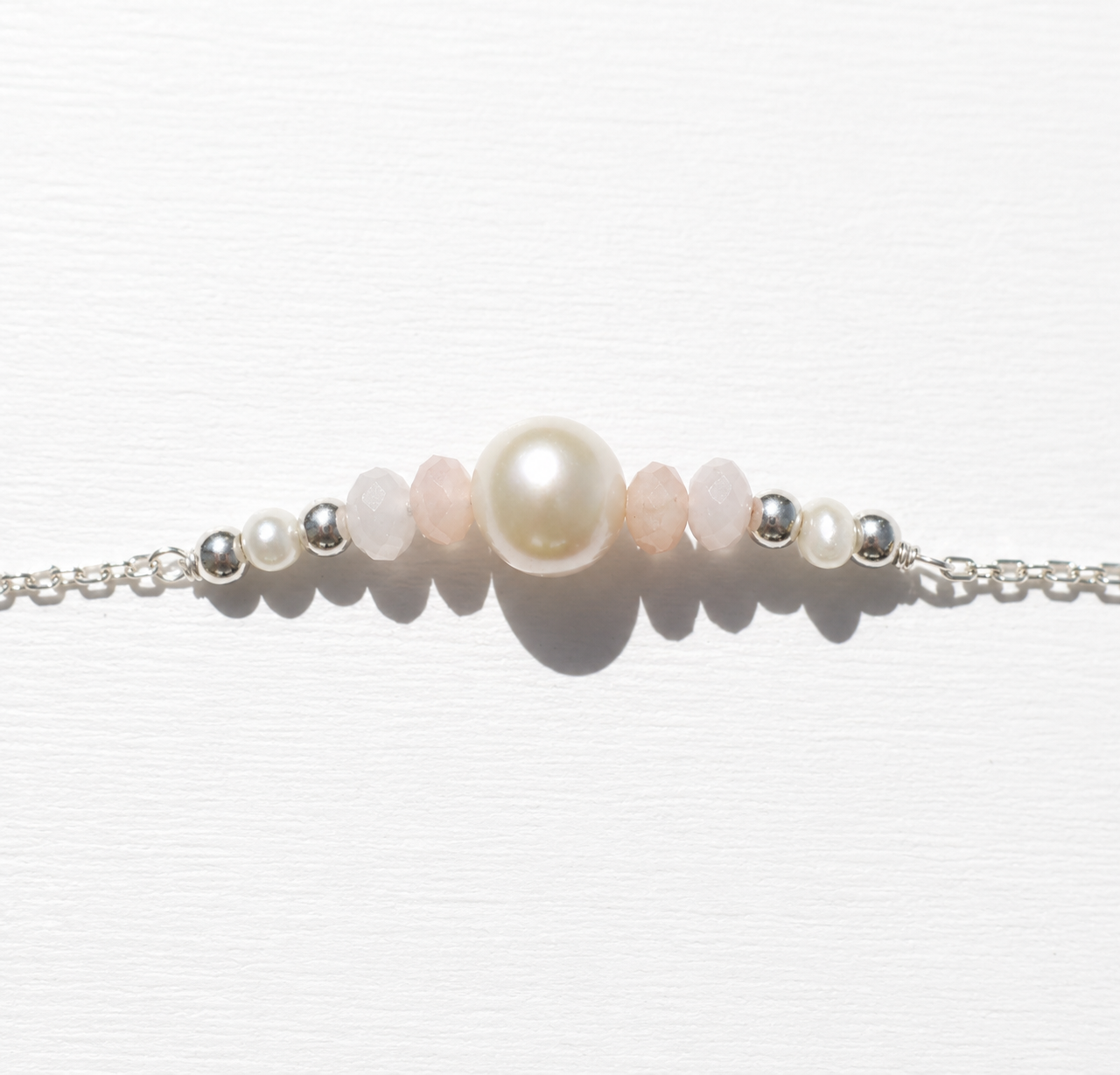 Sea Dreams Pearl Bracelet Pink Opal in 925 sterling silver with genuine freshwater pearl, soft pink opal gemstones, silver tassel details, and adjustable chain