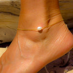 Seaside Glow Gold Vermeil Pearl Anklet worn on ankle, featuring a luminous freshwater pearl and delicate gold chain.