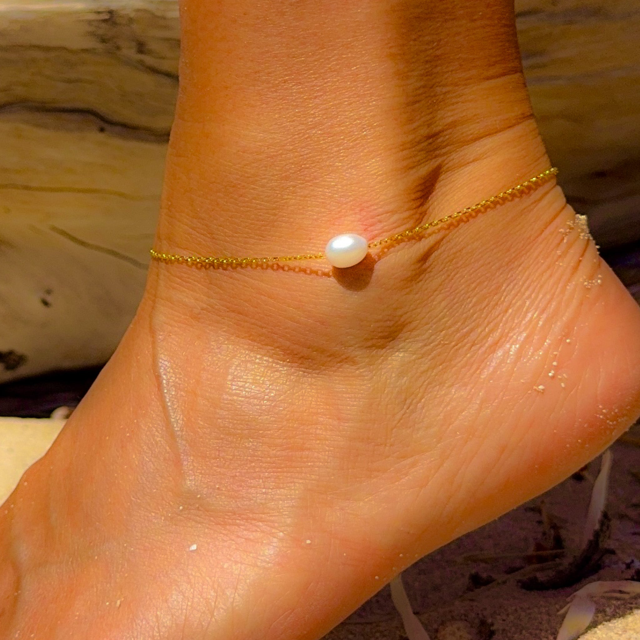 Seaside Glow Gold Vermeil Pearl Anklet worn on ankle, featuring a luminous freshwater pearl and delicate gold chain.
