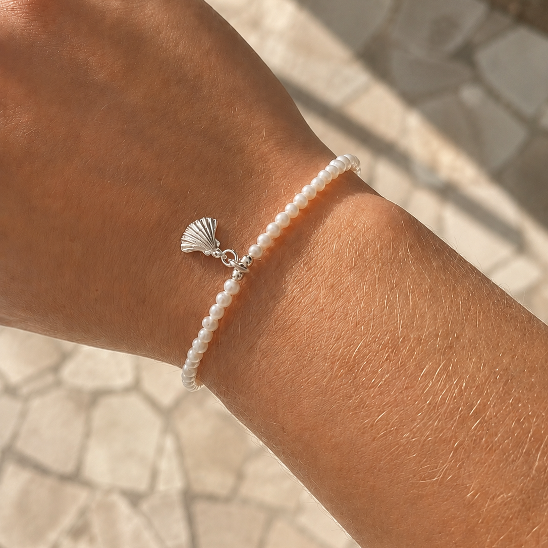 dainty seed pearl bracelet with silver shell charm
