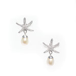 A pair of silver stud earrings featuring a starfish design with a freshwater pearl dangling below each earring.