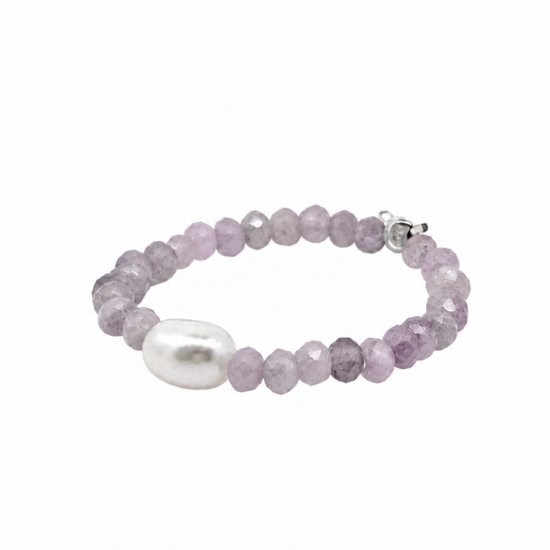 A beaded stretch bracelet featuring faceted light purple gemstone beads with a single white pearl accent bead.
