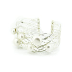 A sterling silver cuff bracelet featuring a wire cage design with freshwater pearls scattered throughout.