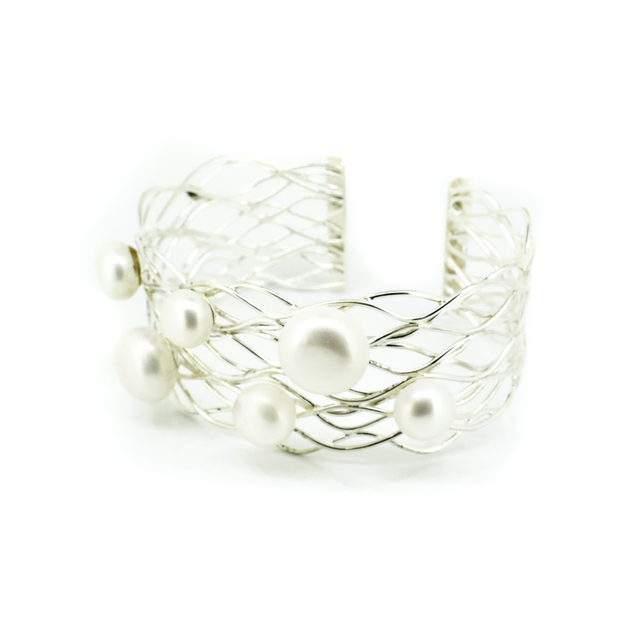 A sterling silver cuff bracelet featuring a wire cage design with freshwater pearls scattered throughout.