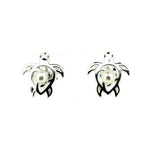 Pair of turtle-shaped earrings with pearl centers on a white background