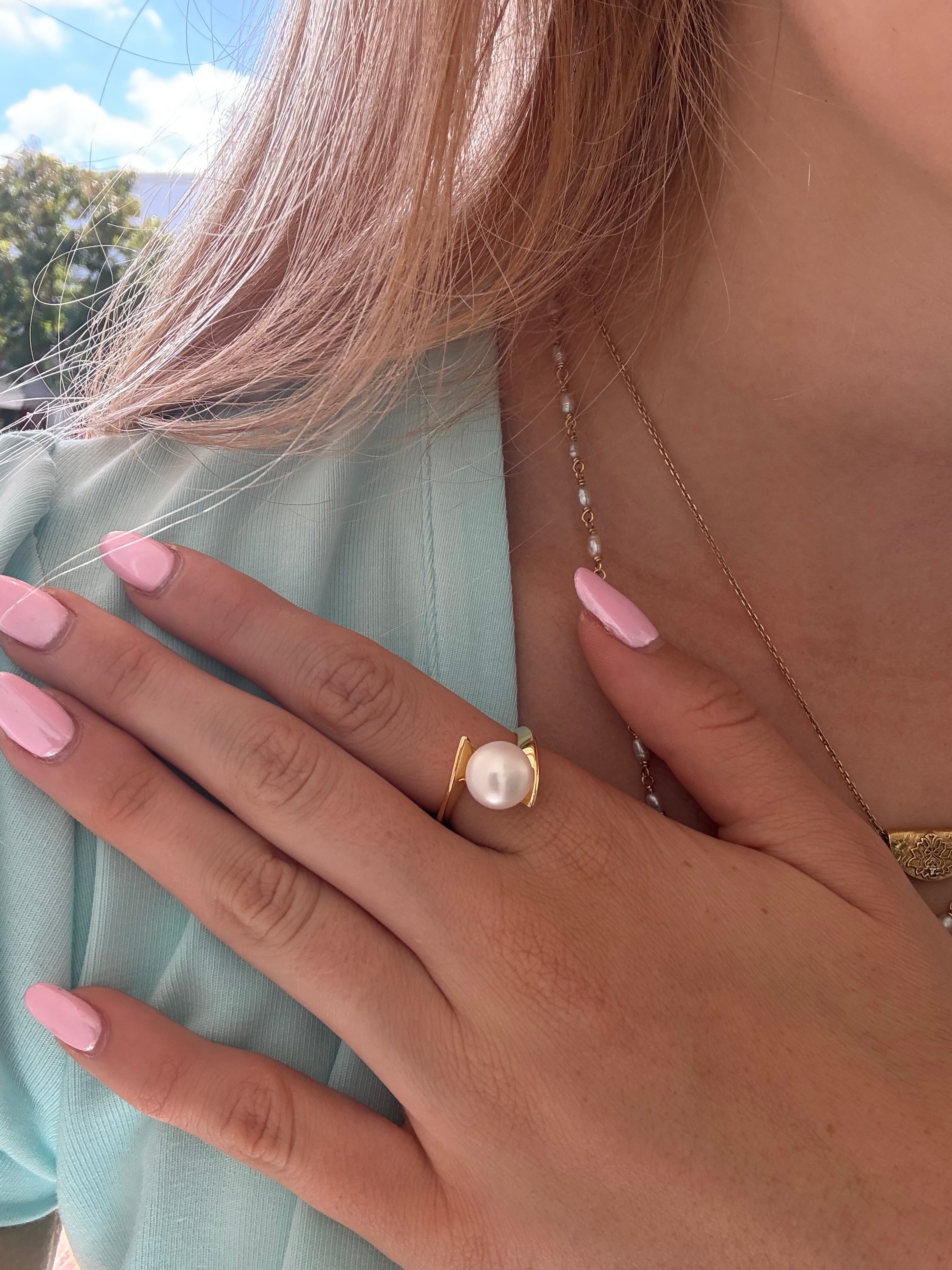 Whirlpool Pearl Ring Gold featuring a genuine freshwater pearl set in a swirling gold vermeil design over 925 sterling silver.