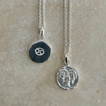 sterling silver necklaces with zodiac sign pendant, double sided one showcasing the Cancer symbol and the other with a dainty chain design, both on sterling silver pendant