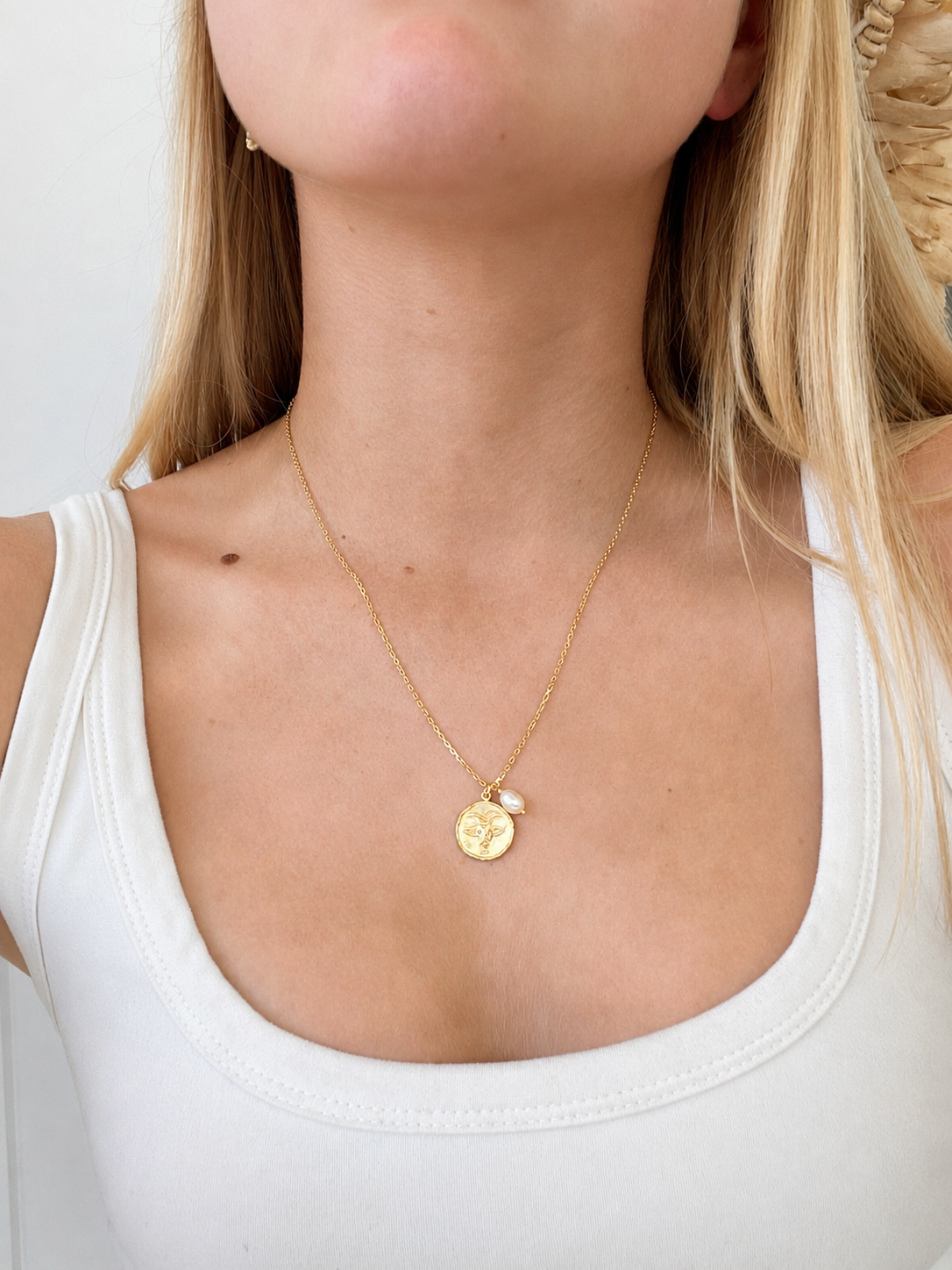 Zodiac Necklace Capricorn Gold in gold vermeil with Capricorn pendant and delicate pearl accent, worn on the neck.