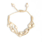 Close-up natural freshwater pearls on camel cord bracelet