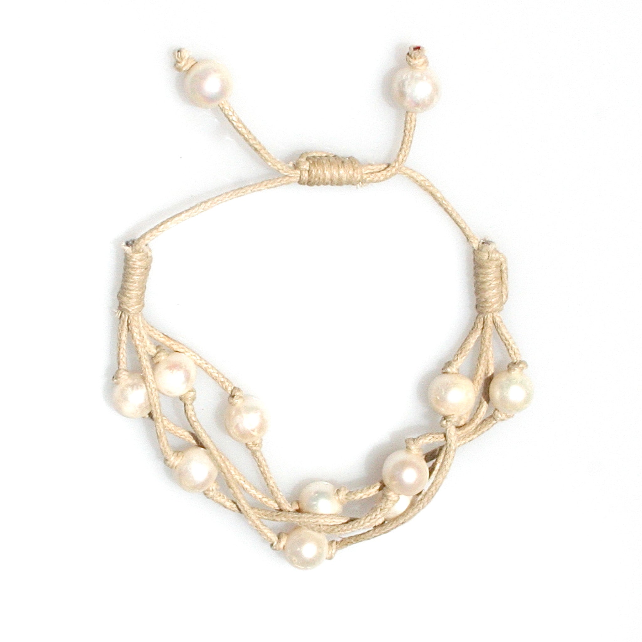 Close-up natural freshwater pearls on camel cord bracelet