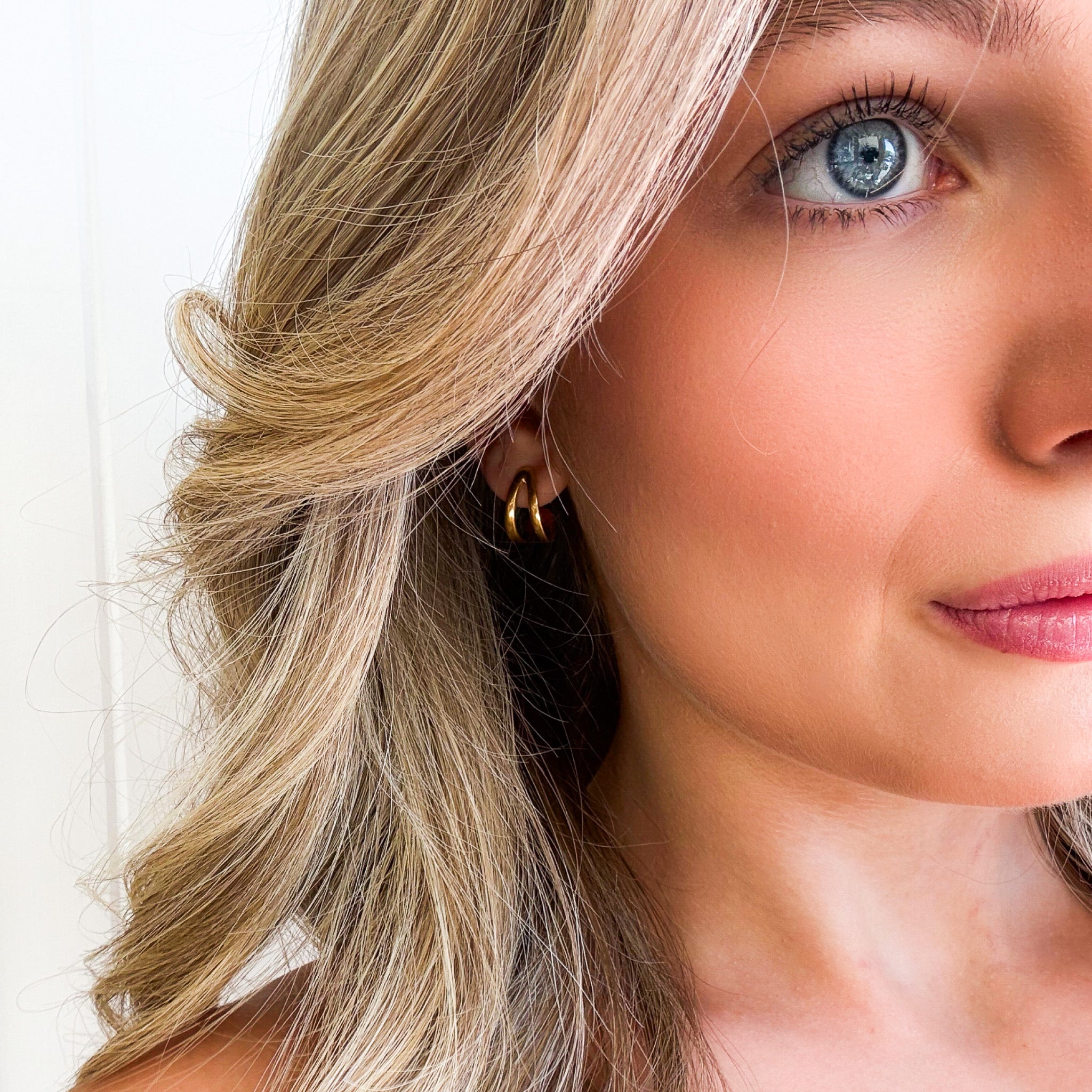 Gold vermeil coastal curl huggie earrings inspired by ocean waves and beachy Australian style