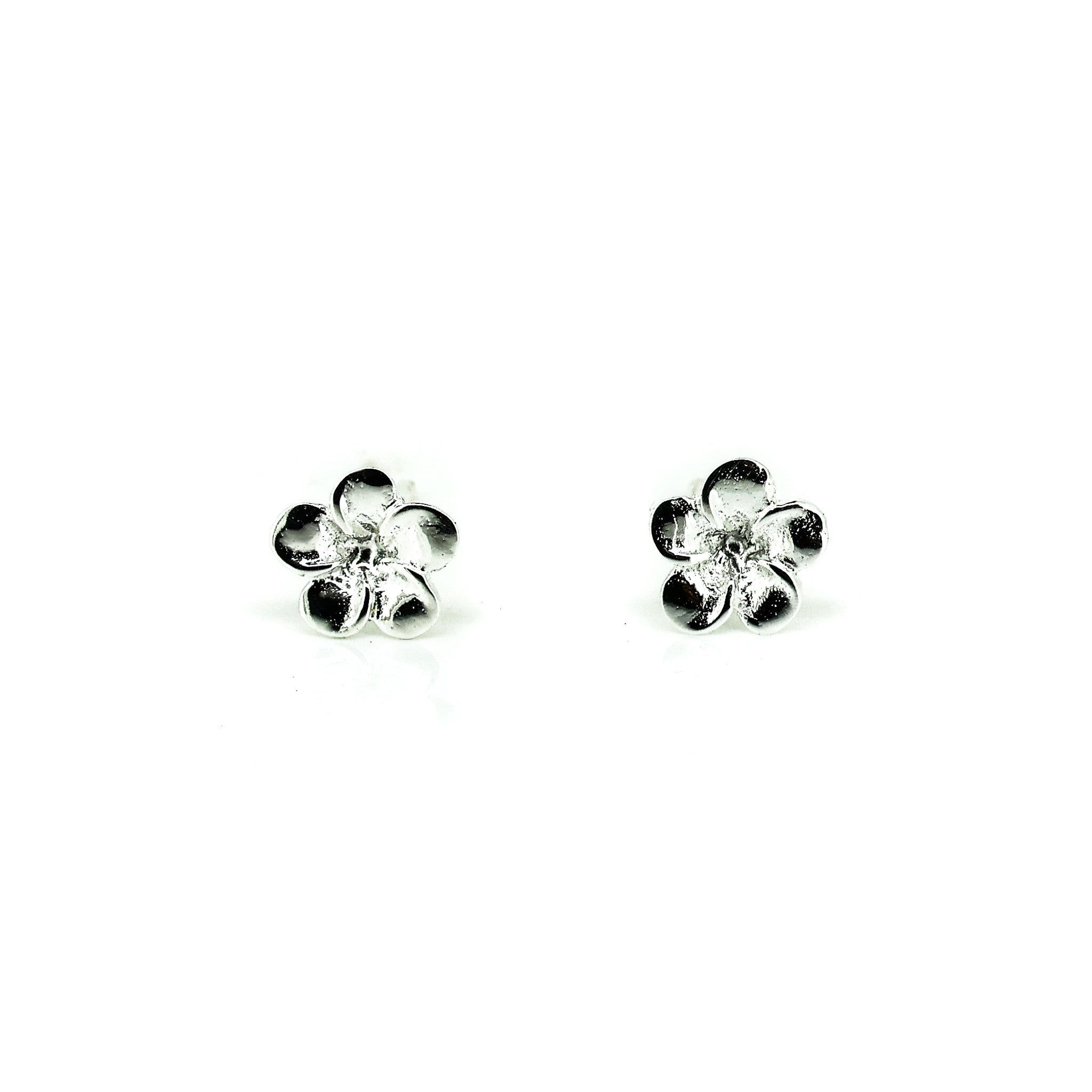 A pair of sterling silver frangipani stud earrings against a white background.