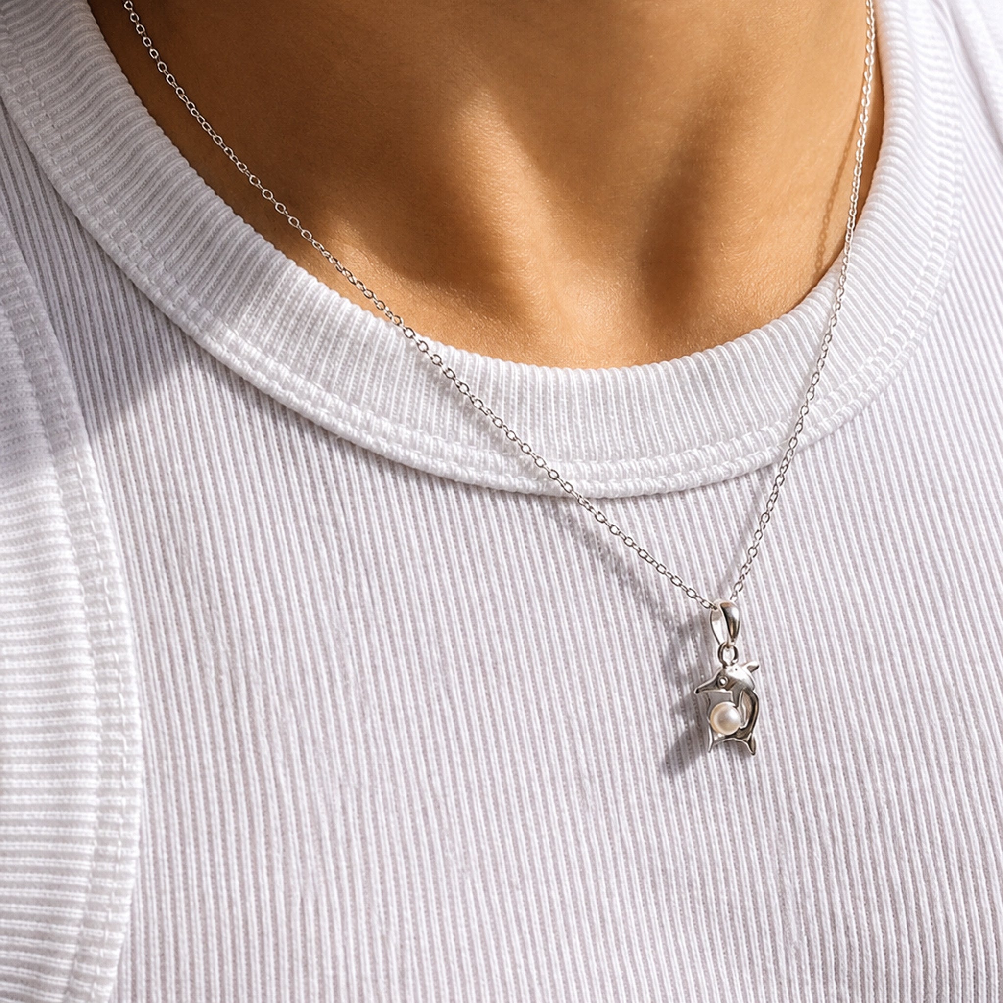 dainty dolphin pendant detailed with a pearl