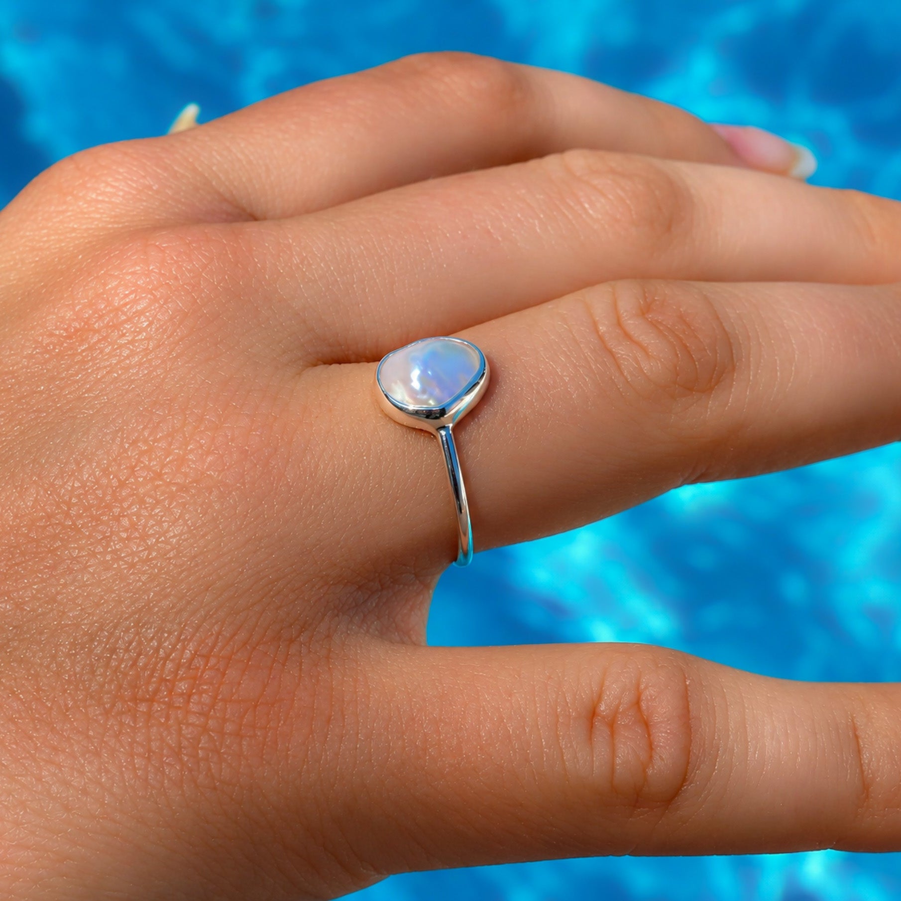model wearing the lush designs drift pearl ring which features a 9mm freshwater organic pearl set in sterling silver
