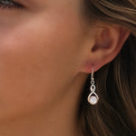sterling silver earrings in a swirl design with a freshwater pearl