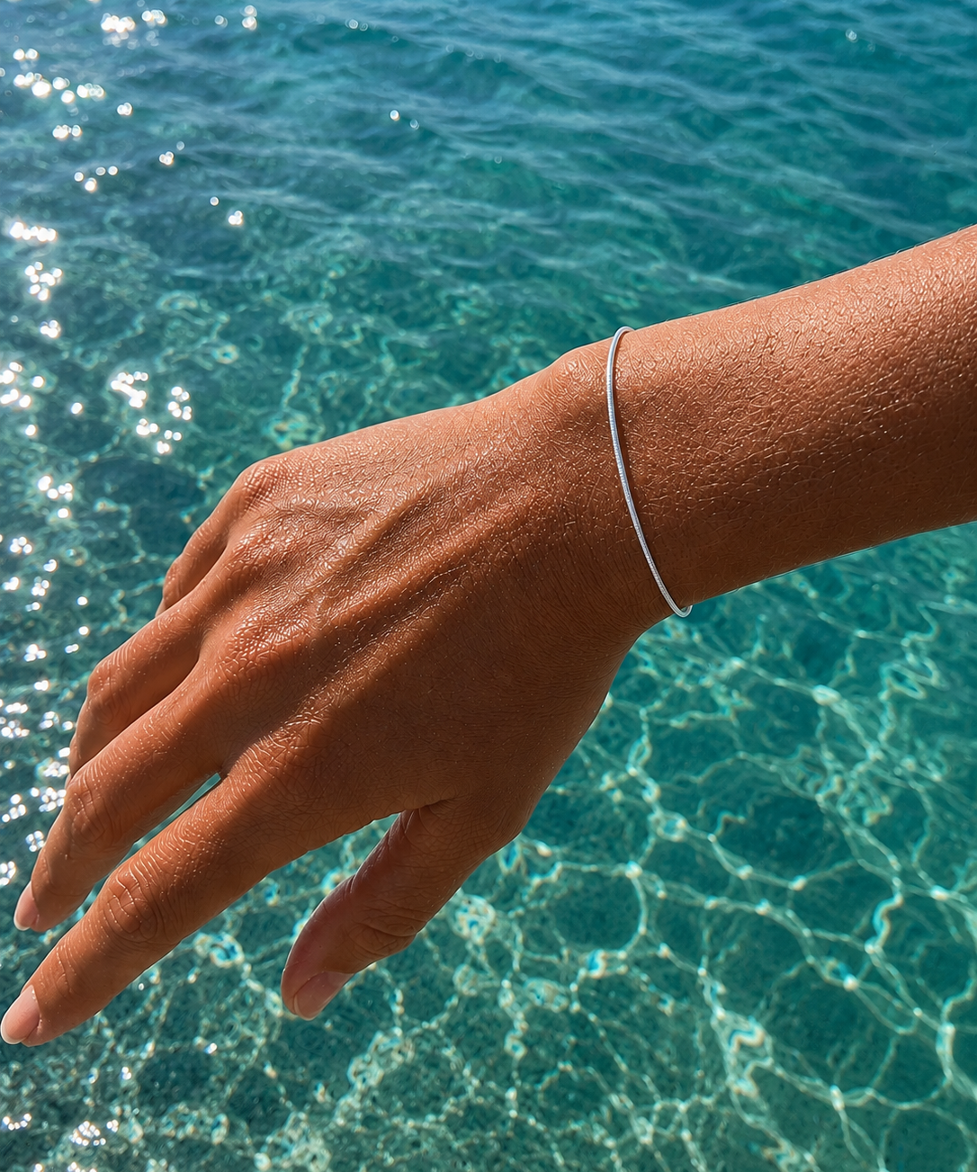 Minimalist Ocean Current Bracelet Silver crafted from 925 sterling silver with a delicate adjustable chain and polished silver finish.