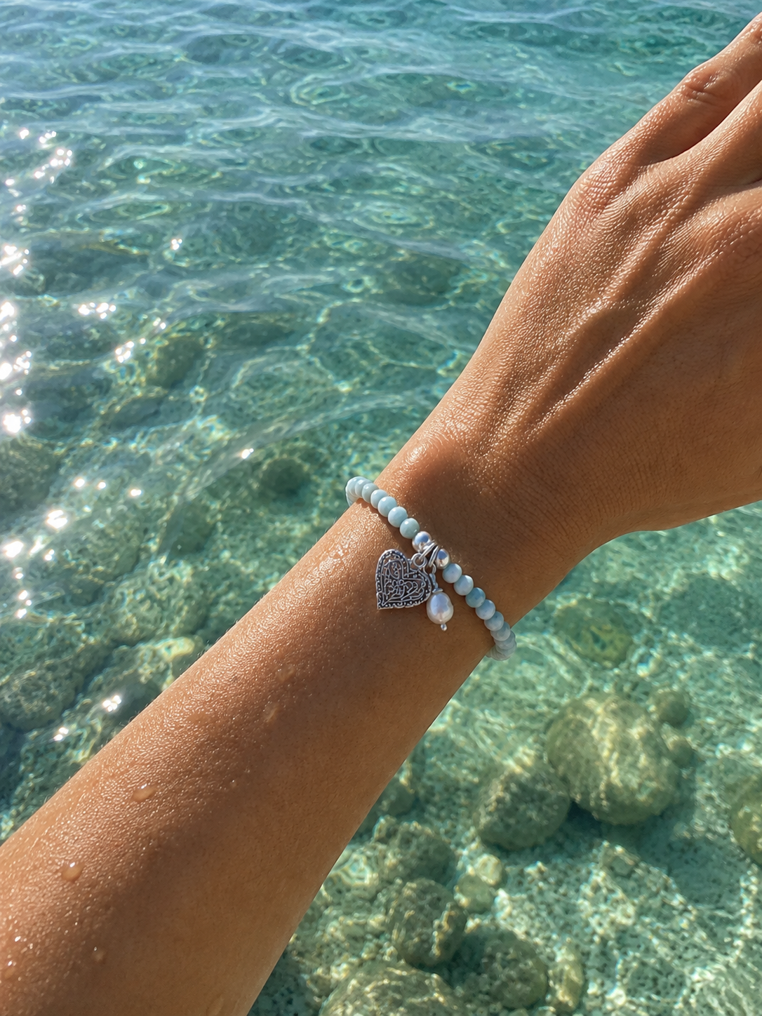 Ocean Hearts Larimar Stretch Bracelet featuring genuine Larimar gemstones, freshwater pearl charm and sterling silver heart charm.