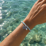Ocean Hearts Larimar Stretch Bracelet featuring genuine Larimar gemstones, freshwater pearl charm and sterling silver heart charm.