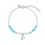 Light blue gemstone and freshwater pearl bracelet featuring delicate white pearls, soft blue beads and sterling silver accents on an adjustable design. A beach-inspired bracelet handcrafted for effortless coastal sty
