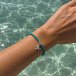 Ocean Spell Stretch Bracelet with turquoise gemstones and sterling silver starfish charm on a stretch bracelet design.