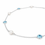 Delicate 925 sterling silver chain with bezel-set blue topaz stones and 9mm freshwater pearls