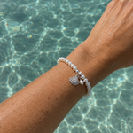 Pearl Silk Knot Bracelet Shell Pearl Charm featuring genuine freshwater pearls and a sterling silver shell charm.
