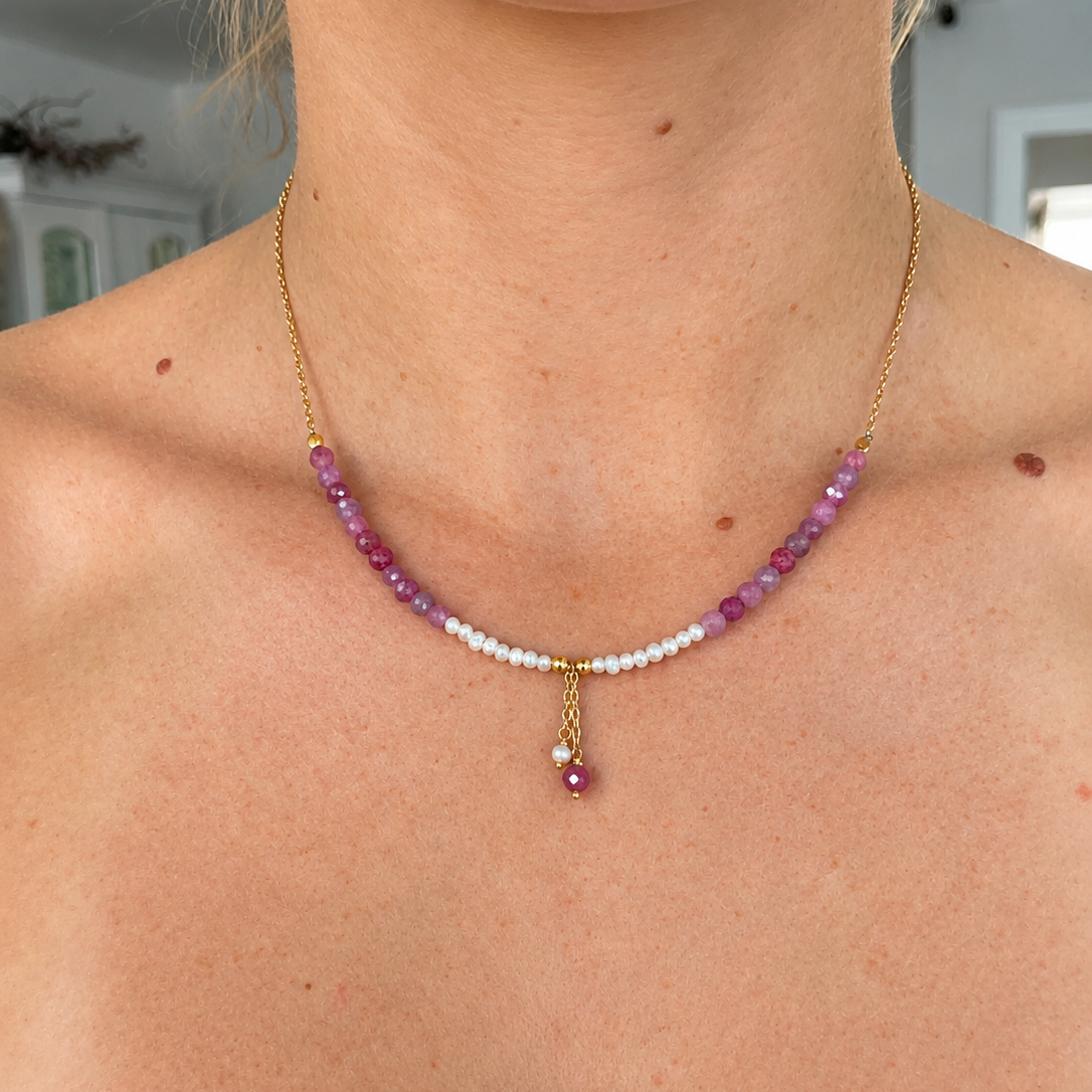 Model wearing a delicate pink and purple faceted gemstone necklace featuring natural white freshwater pearls, gold vermeil chain and dangling pearl and gemstone charms. Coastal-inspired jewellery by Lush Designs Jewellery, designed in Broome, Western Australia.