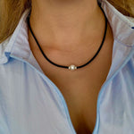 pearl necklace on black neoprene