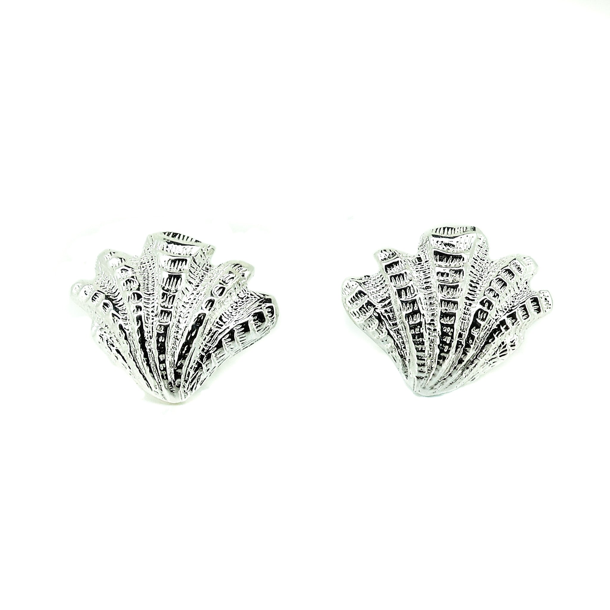 Bold sterling silver shell stud earrings with detailed textured coastal shell design inspired by European summer beach jewellery.