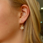 Seastar sparkle earrings gold vermeil with cubic zirconia starfish design worn by model beachy style