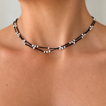 Close-up of model wearing the Summer Sun Pearl Necklace Black, featuring delicate 3mm freshwater rice pearls on layered black cotton strands, made in Broome Western Australia.